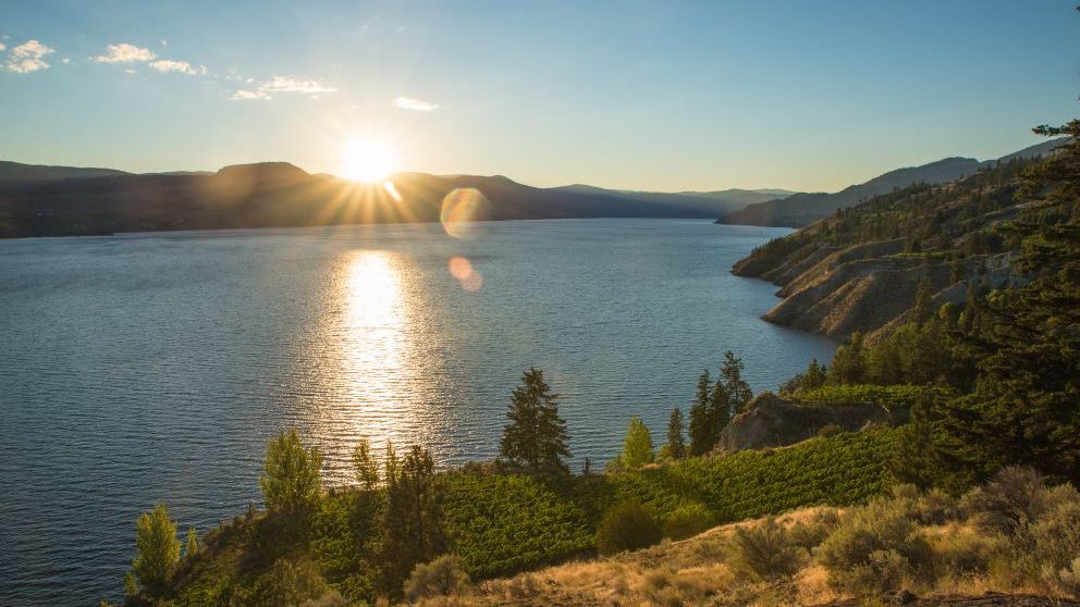The beautiful Okanagan Lake in Canada surrounded by forested mountains